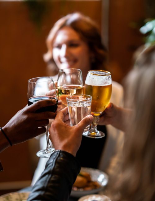 Group of people cheering with beers and wine at SERRA